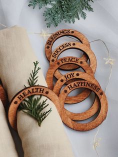 six wooden rings with the words happiness, success and peace are sitting on a pillow