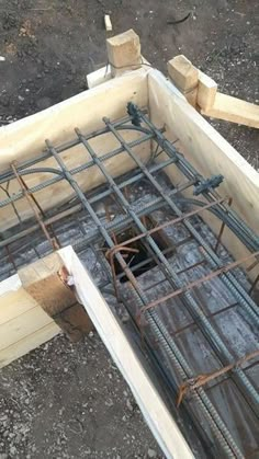 a building being constructed with steel bars and wooden posts