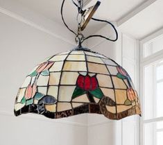 a stained glass lamp hanging from the ceiling