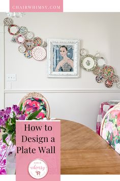 a dining room table with plates on the wall and flowers in vases next to it