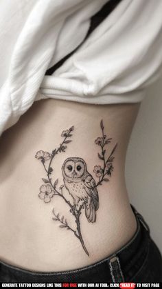 an owl tattoo on the side of a woman's stomach, with flowers growing out of it