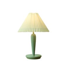 a green table lamp with a white shade