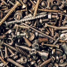 there are many screws and nuts in this pile