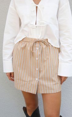 The cutest little skirt to take into fall. The Treat Yourself Skort is a high rise pull on skort with a drawstring waistband and button front detail in a beige and cream colored stripe. 


Katie is 5'5" and is wearing size small

size small measurements: 27" waist | 14.5" length

55% cotton | 45% polyester


WE ONLY OFFER STORE CREDIT FOR RETURNS! Feel free to email us at orders@shopriffraff.com or DM us with any questions regarding fit, styling, or our return policy in general. Western Tee, Love Hat, Gameday Outfit, Color Stripes, Drawstring Waistband, Cardigan Jacket, Treat Yourself, Tee Shop, Cream Color