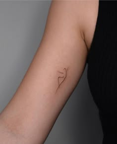 a woman's arm with a small tattoo on the left side of her arm