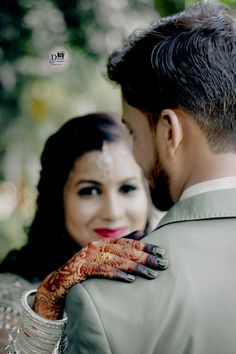 the bride and groom are looking at each other