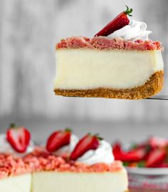 a piece of cheesecake being lifted by a fork with strawberries on the side