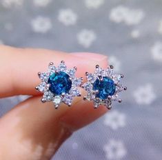 Welcome to Elegant Art Jewelry!  Material: 925 Sterling Silver Stone: Blue Topaz Stone Size: 5mmX5mm Side Stone: Zircoin Plating: Platinum plating Personalization: 9K/14K/24K/GOLD/SILVER/PLATINUM/ROSE-GOLD/WHITE GOLD. (Contact me)  Topaz Earrings, Topaz Cuff Earrings, Gold Earrings, Gold Stud Earrings, 14k Gold Earrings, 14k Gold Earrings, Round Cut Earrings, Round Cut Stone Earrings, Round Cut Studs Earrings, Topaz Drop Earrings, Topaz Studs Earrings, Topaz Studs, Topaz Earrings, Topaz Dangle E Blue Topaz Earrings Studs, Silver Sapphire Earrings With Sparkling Stones, Blue Cubic Zirconia Round Earrings, Blue Halo Design Earrings As Gift, Sapphire Cubic Zirconia Round Earrings, Round Sapphire Cubic Zirconia Earrings, Dazzling Sapphire Earrings For Gift, Blue Sapphire Cluster Earrings For Gift, Dazzling Blue Cubic Zirconia Earrings