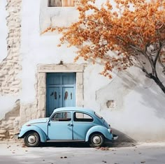 an old blue car parked in front of a white building with a tree next to it