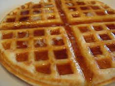 two waffles with syrup on them sitting on a table