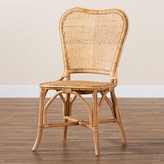 a wicker chair sitting on top of a hard wood floor next to a wall