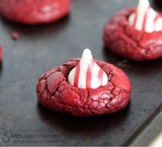 red velvet cookies with white frosting and candy canes on top are ready to be eaten