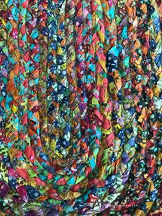 a multicolored piece of cloth with many different colors and shapes on it's surface