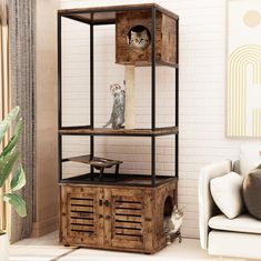 a cat sitting on top of a wooden crate in a living room next to a couch