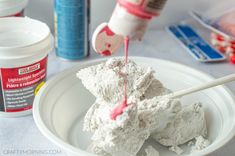 a white plate topped with marshmallows covered in icing