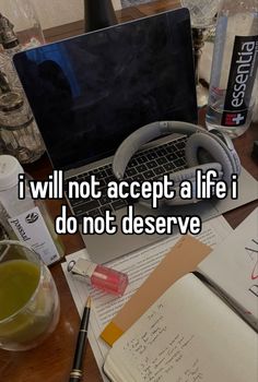 an open laptop computer sitting on top of a desk next to a notepad and pen