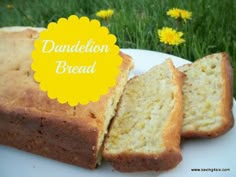 a white plate topped with two slices of cake next to yellow dandelion flowers