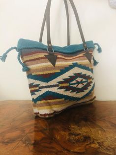 "Gorgeous Large wool Tote Bag,purse,Blanket Purse,Boho Bag,Woven ,Shoulder Bag ,Black,Turquoise, Brown, Red, Earth tones, Leather straps This is a really beautiful large woven wool Tote with an Indian, Southwestern design in superb condition Snap closure Lined with one zip close large interior pocket Awesome Earthy Boho look Excellent condition PLEASE SEE MEASUREMENTS Measures: W 19\" x H 14\" x Depth 4\" Double Straps: drop 11\" NK Gorgeous Large wool Tote Bag,purse,Blanket Purse,Boho Bag,Woven Bohemian Turquoise Travel Bag, Bohemian Turquoise Bags For Festival, Southwestern Multicolor Bags For Everyday Use, Multicolor Southwestern Bags For Everyday Use, Blue Bohemian Satchel Hobo Bag, Bohemian Blue Hobo Satchel Bag, Handmade Turquoise Shoulder Bag For Daily Use, Handmade Turquoise Shoulder Bag For Travel, Blue Bohemian Hobo Bag