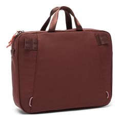 a brown laptop bag sitting on top of a white table