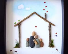 a frame with rocks in the shape of a house