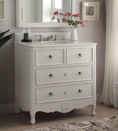 a white dresser and mirror in a room