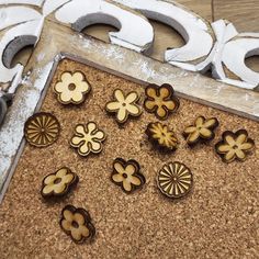 some wooden buttons are laying on a cork board