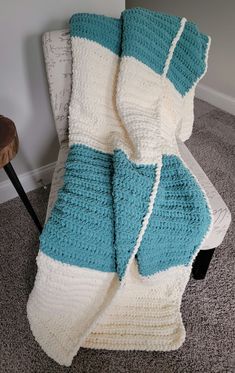 a crocheted blanket sitting on top of a chair