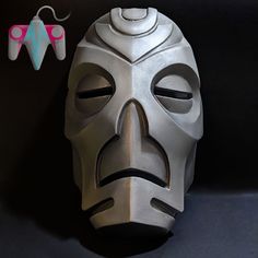 a mask is sitting next to a pair of scissors