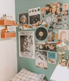 a bedroom with posters and pictures on the wall