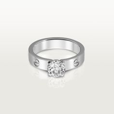 a white gold ring with a single diamond