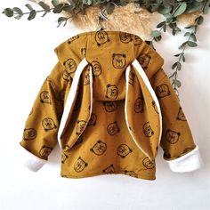 Warm unisex bunny jacket with super warm fleece lining and rabbit ear hood for boys and girls. With a cheery brown print and teddy bears, kids will feel warm and comfortable. The jacket closes with clip buttons. If you want to see more jackets like this you can see them here, https://www.etsy.com/shop/Blumykakids?ref=seller-platform-mcnav&section_id=36325704 You can see the sizes in our size chart, please measure the child to see what size fits him best. To be able to choose the correct size, co Cute Winter Hooded Jacket With Adjustable Hood, Cute Hooded Fleece Outerwear, Cute Winter Outerwear With Drawstring Hood, Brown Hooded Jacket With Detachable Hood, Brown Long Sleeve Hooded Jacket With Detachable Hood, Cute Fleece Outerwear For Winter, Cute Fleece Outerwear With Drawstring Hood, Winter Cotton Brown Hooded Jacket, Brown Cotton Hooded Jacket For Winter