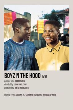 two men standing next to each other in front of a sign that says boyz n the hood