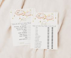 two baby shower games on a bed with pink and gold stars in the sky above them