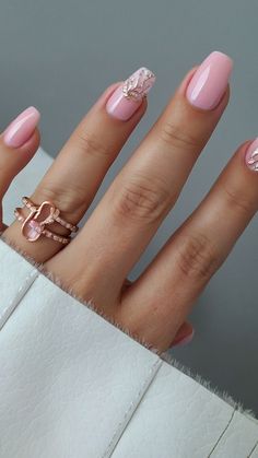 a woman's hand with pink manies and rings