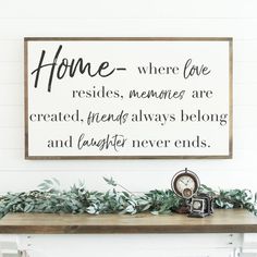 a sign that reads home where love resides, memories are created friends always belong and laughter never ends