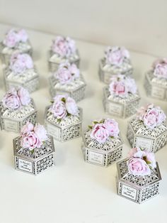 there are many small boxes with flowers in them