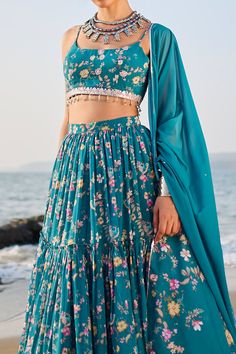 Teal A-line flare tiered lehenga, highlighted with all over floral and kingfisher bird print. Paired with a sleeveless blouse with all over floral print and dupatta.
Component: 3
Pattern: Print
Type Of Work: Floral,Kingfisher Bird
Neckline: Scoop Neck
Sleeve Type: Sleeveless
Fabric: Georgette
Color: Blue,Green
Other Details: 
Attached can-can
Crystal laced blouse
Sequin embellishments
Floral print dupatta
Occasion: Reception,Sangeet - Aza Fashions Tiered Lehenga, Kingfisher Bird, Crystal Lace, Fashion App, Bird Print, Kingfisher, Bird Prints, Lace Blouse, Set For Women