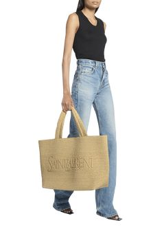 "Find SAINT LAURENT East-west Logo Raffia Tote Bag on Editorialist. Saint Laurent raffia and viscose tote bag with logo across front Flat shoulder straps, 8.2\" drop Open top Interior, one slip pocket Bronze hardware Approx. 13.7\"H x 16.9\"W x 7\"D Imported" Designer Natural Bags With Rolled Handles, Designer Bags For Summer Shopping, Designer Summer Bags For Shopping, Designer Natural Bags For Summer, Designer Natural Color Summer Bag, Luxury Summer Bag With Rolled Handles, Ysl Tote Bag, Ysl Tote, Saint Laurent Tote