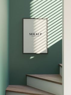 a poster hanging on the wall next to some stairs with sunlight coming through it and casting shadows