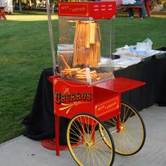 an old fashioned hot dog cart on the sidewalk