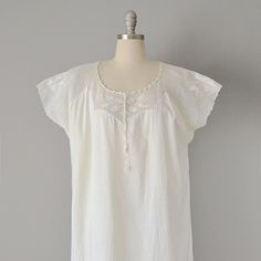 "This Victorian night gown is made from soft, off-white cotton in a beautiful, simple design. The top has a yoke of crocheted cotton lace, with a rounded, drawstring collar. Dolman-like sleeves transition into the straight cut skirt of the piece. Would look great belted, or on its own as a summer day look. Pullover fit. Size: M, L, XL. Bust: 52\" Waist: 56\" Hips: 56\" Length: 58\" Label: None. Condition: Excellent vintage condition (tiny pin-hole near front hem). All vintage is sold in \"as-is\ Cotton Delicate Lace Dress For Daywear, White Crochet Lace Dresses For Daywear, 1800s Dresses Victorian, Lace Chemise, Women's Nightgowns, Pin Hole, Nightgowns, Summer Day, Cotton Lace