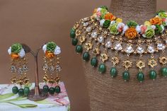 an assortment of jewelry is displayed on a mannequin