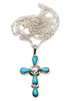 Turquoise inlay cross pendant handcrafted by Zuni artist Bryce Vacit with imported 18" silver chain. Pendant is 1 1/8" x 5/8" and weighs 2.7 grams +-. Spiritual Cross Turquoise Necklace For Gift, Spiritual Turquoise Cross Necklace As Gift, Spiritual Turquoise Cross Necklace For Gift, Spiritual Turquoise Cross Necklace, Silver Turquoise Cross Necklace For Gift, Spiritual Turquoise Necklace With Cross Pendant Gift, Spiritual Turquoise Cross Pendant Necklace Gift, Handmade Silver Cross Turquoise Necklace, Turquoise Cross Pendant Necklace As Gift