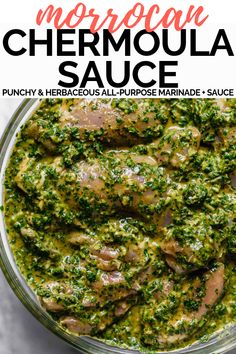 a glass bowl filled with meat covered in pesto sauce and garnished with parsley