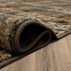 an area rug is laying on the floor with it's end rolled up to look like a carpet