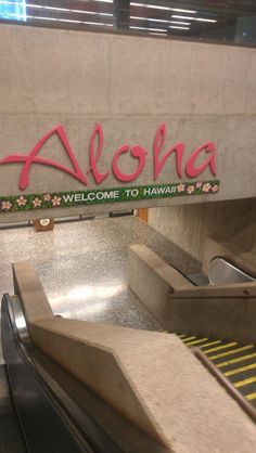 an escalator with the word aloha painted on it