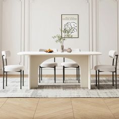 a white table with four chairs around it