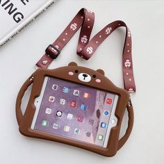 an ipad case with a bear design on the front and shoulder strap attached to it