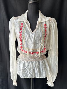 Beautiful nylon embroidered peasant blouse! Great vintage condition; has a couple small snags. Please see photos for those details. Sold as-is.  Blouse has one left side metal hook closure and ties in the front.  Measurements taken laying flat:  Pit to pit- 20" Waistband- 12"-13.5" (stretches) Sleeve length- 27" Garment length- 24" Bohemian Embroidered Peasant Top For Daywear, Folk Style Peasant Top With Boho Collar For Spring, Traditional Spring Blouse With Boho Collar, Bohemian Smock Peasant Top For Spring, Spring Festival Blouse With Boho Collar, Embroidered Peasant Top For Spring Daywear, Spring Festival Boho Collar Blouse, Bohemian Smock Blouse For Daywear, Spring Peasant Blouse