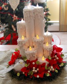 a cake that is sitting on top of a table with candles in the shape of a castle